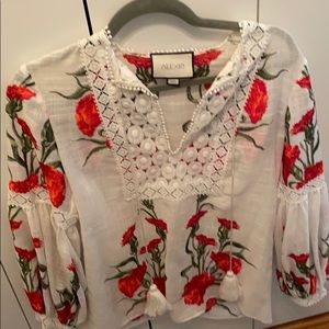 A super cute woman’s white floral blouse
